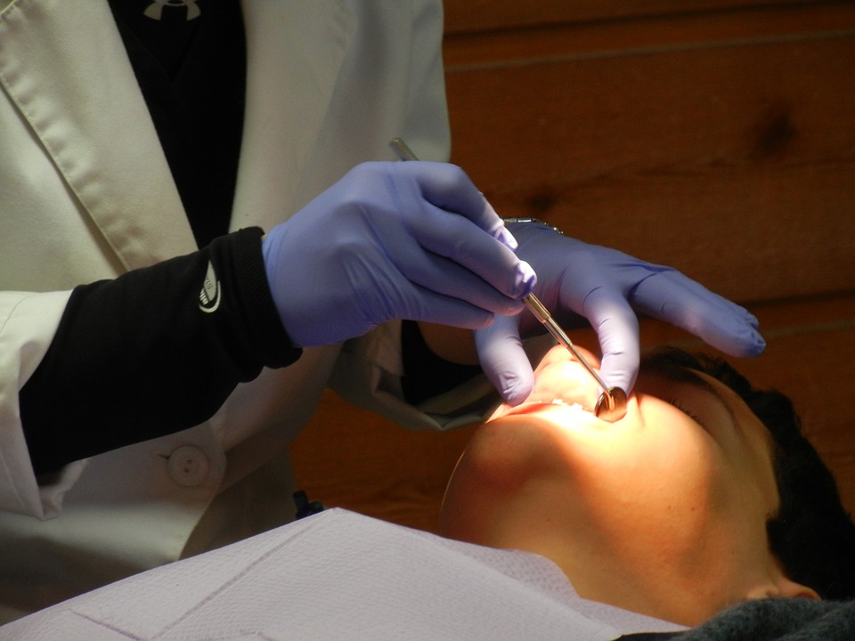 A dentist checking on the patient's teeth - Mississauga Dentist - Bristol Dental